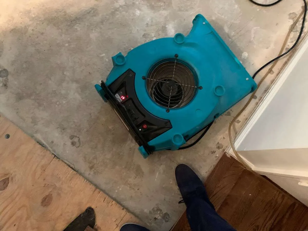 Air mover drying subfloor during Commercial Water Damage Restoration in Villa Park